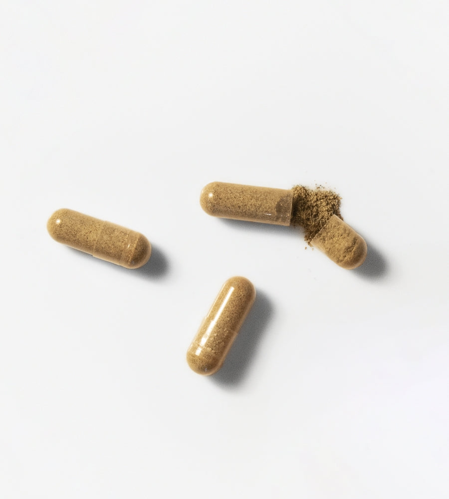 capsules of supplements sitting open on white background