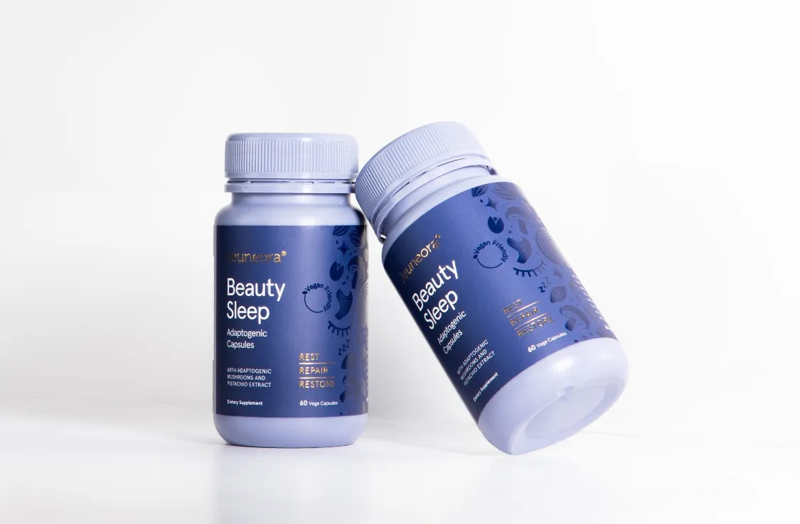 Two containers of Jeuneora beauty sleep capsules leaning up against each other on a white background