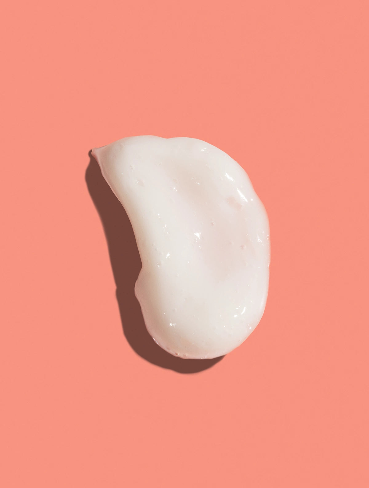 OhWhippy™ Prebiotic Cream Cleanser texture on pink background